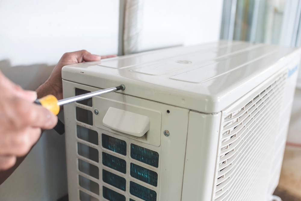 A technician screwing the outdoor compressor of a newly installed split type air conditioner in Melbourne